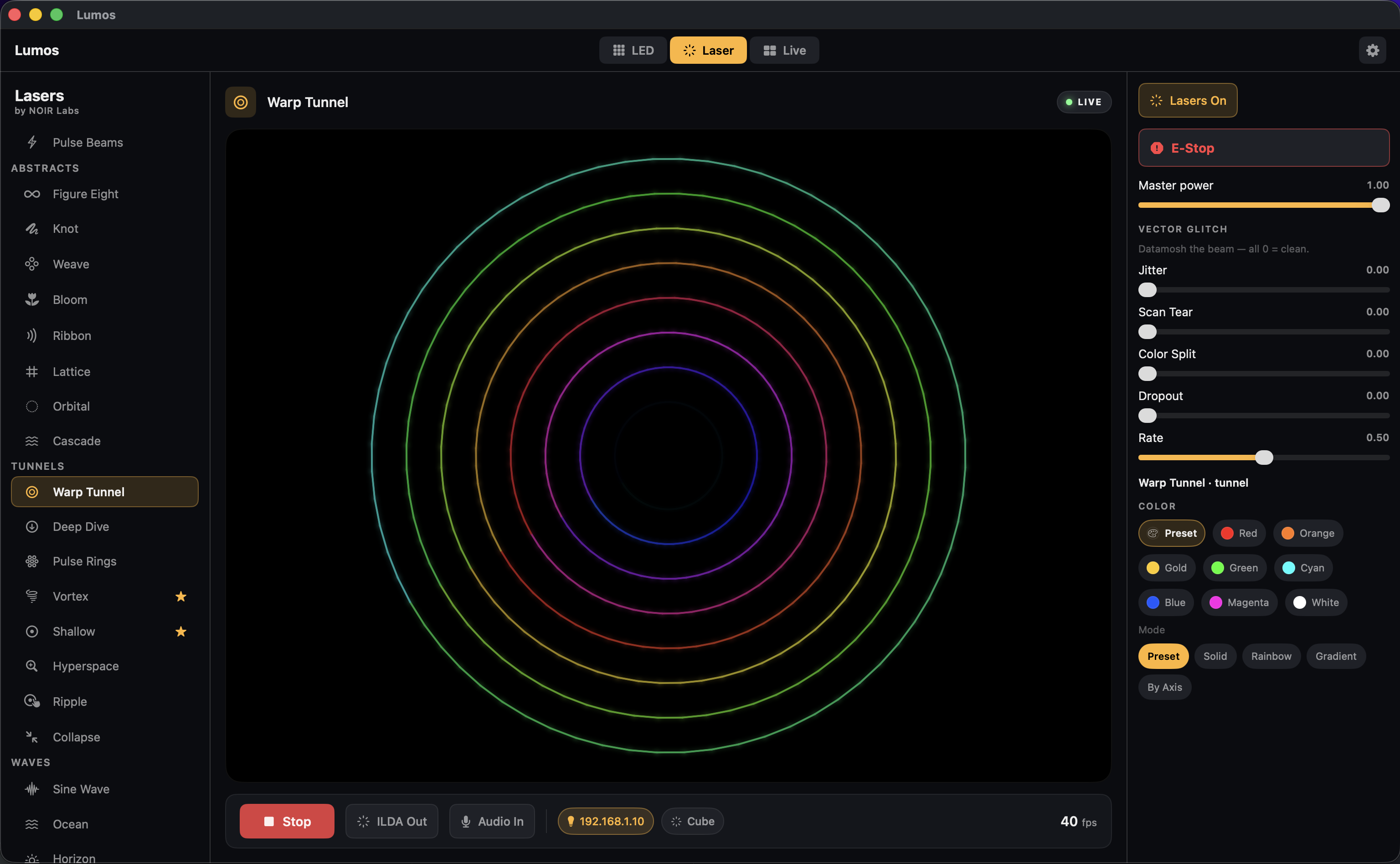 NOIR Lumos Laser mode on macOS: the Warp Tunnel preset rendering concentric rainbow rings, with the laser preset library, vector-glitch (datamosh) controls, color swatches and modes, master power and an E-Stop.